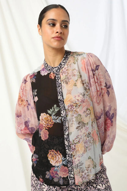 Mackenzie Shirt - Kachel
Meet the Mackenzie Shirt by Kachel - perfectly styled with the Julia Pant for a look that's effortlessly chic.

With its high collar neckline and long puffed sleeves finished with neat cuffs, it's got just the right amount of drama. The delicate floral print adds a lovely feminine touch, making it ideal for everything from workdays to weekend plans. Dress it up or keep it casual - either way, the Mackenzie Shirt brings timeless style with a modern twist.
