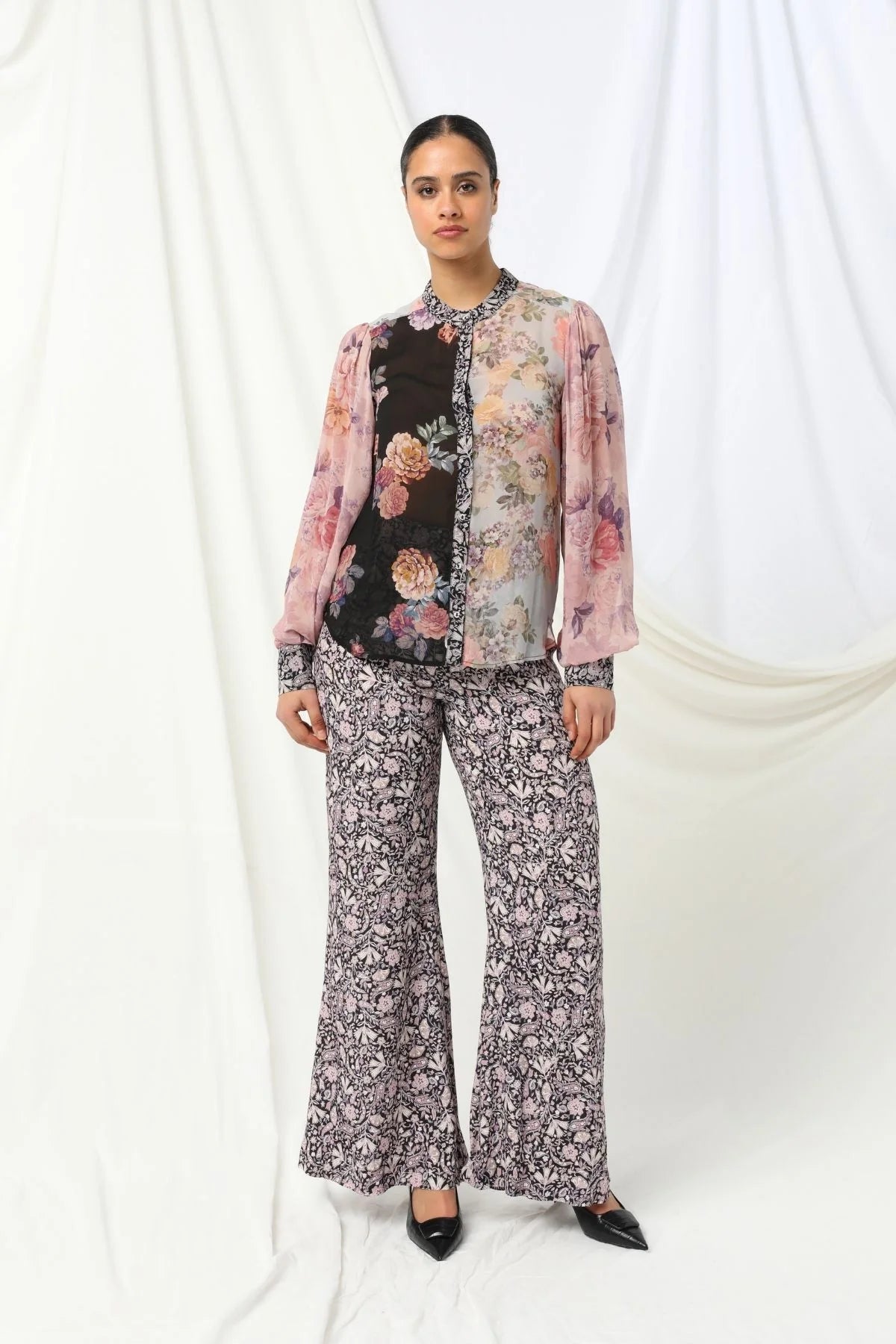 Mackenzie Shirt - Kachel
Meet the Mackenzie Shirt by Kachel - perfectly styled with the Julia Pant for a look that's effortlessly chic.

With its high collar neckline and long puffed sleeves finished with neat cuffs, it's got just the right amount of drama. The delicate floral print adds a lovely feminine touch, making it ideal for everything from workdays to weekend plans. Dress it up or keep it casual - either way, the Mackenzie Shirt brings timeless style with a modern twist.
