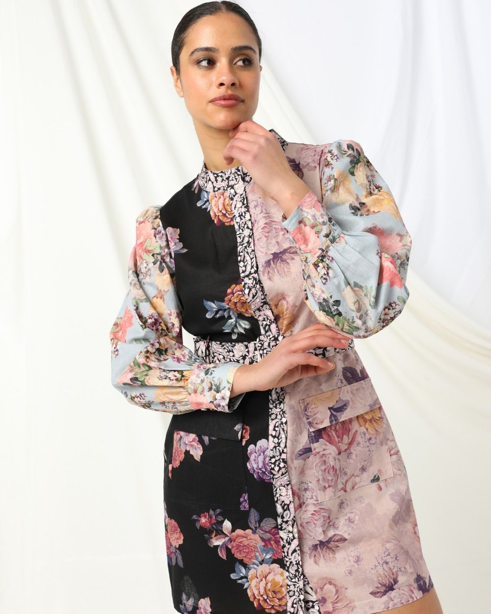 The Kachel Angie Mini Dress brings together modern femininity and everyday ease. This long‑sleeve mini features a high round neckline, button‑up front, and a flattering adjustable belt that allows you to define the waist your way. A beautifully contrasting coloured floral design adds a vibrant touch, while the black and white floral placket introduces a subtle, graphic contrast that elevates the entire silhouette.
