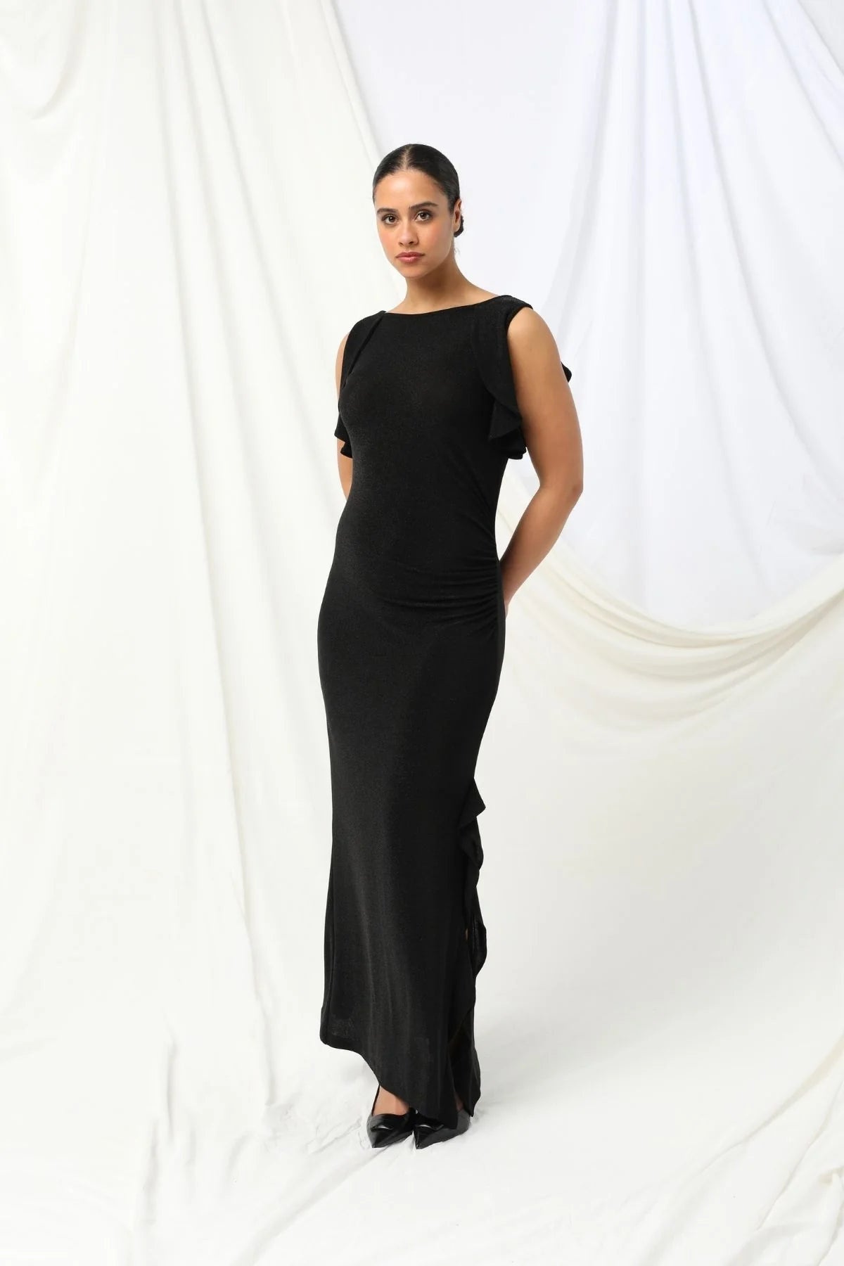 Lydia Dress - Kachel 
Super chic and effortlessly classy, the Lydia Maxi Dress by Kachel is a must-have addition to your wardrobe.

This stunning dress is all about fun, flair, and feeling fabulous. Featuring a graceful boat neckline, soft ruffled cap sleeves, and a floaty ruffled split hem, it's made to move with you. The sleek black hue adds an elegant touch, making it perfect for parties or whenever you're in the mood to dress up and stand out.