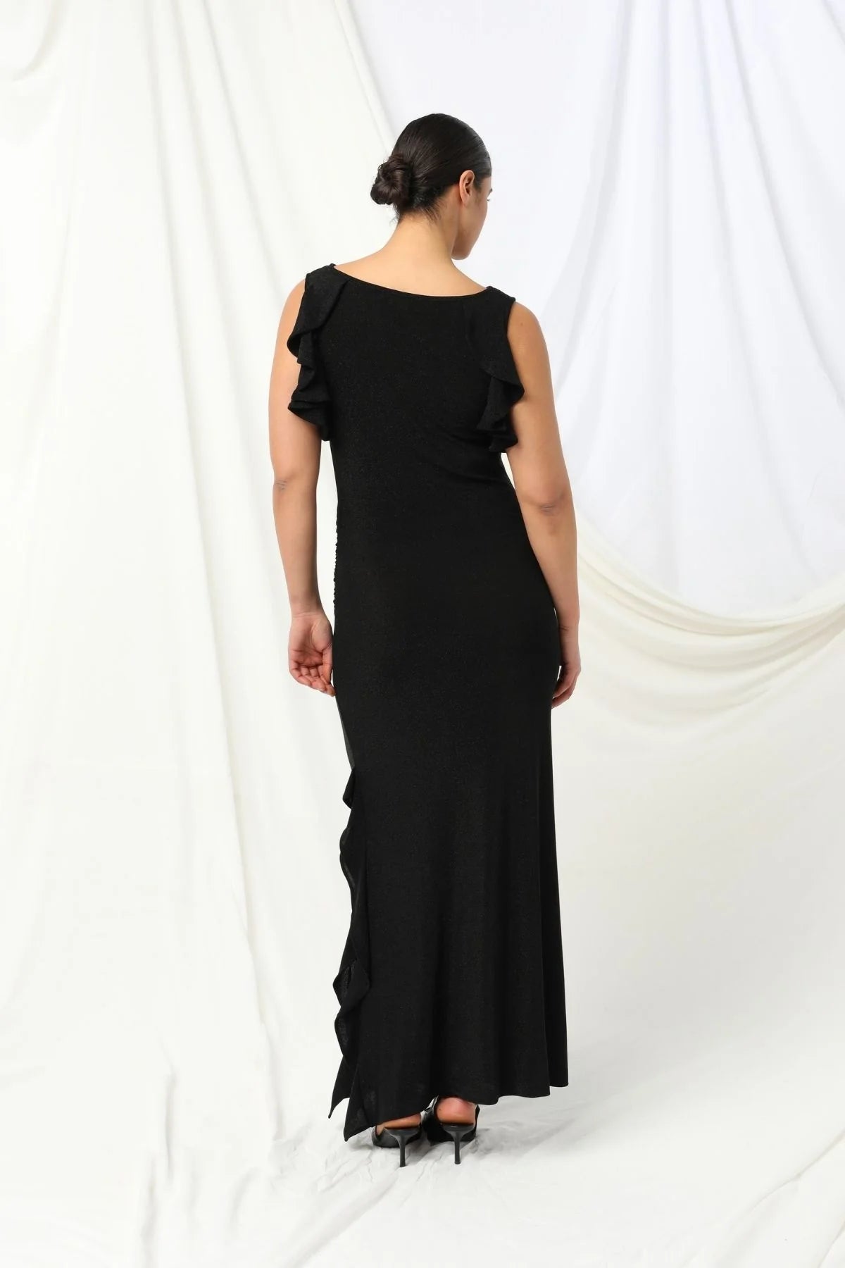 Lydia Dress - Kachel 
Super chic and effortlessly classy, the Lydia Maxi Dress by Kachel is a must-have addition to your wardrobe.

This stunning dress is all about fun, flair, and feeling fabulous. Featuring a graceful boat neckline, soft ruffled cap sleeves, and a floaty ruffled split hem, it's made to move with you. The sleek black hue adds an elegant touch, making it perfect for parties or whenever you're in the mood to dress up and stand out.