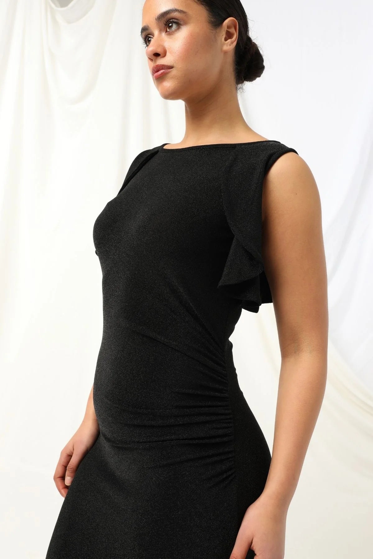 Lydia Dress - Kachel 
Super chic and effortlessly classy, the Lydia Maxi Dress by Kachel is a must-have addition to your wardrobe.

This stunning dress is all about fun, flair, and feeling fabulous. Featuring a graceful boat neckline, soft ruffled cap sleeves, and a floaty ruffled split hem, it's made to move with you. The sleek black hue adds an elegant touch, making it perfect for parties or whenever you're in the mood to dress up and stand out.