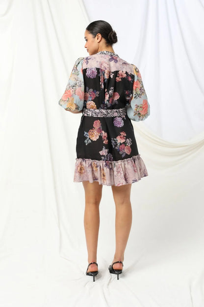 Sasha Mini Dress - Kachel 
Presenting the Sasha Mini Dress by Kachel - cute and fresh and made to flatter.

Featuring short puff sleeves and a high neckline, this playful mini is finished with a classic button-up front and a waist tie to cinch the waist just right. The frilled hem adds a dash of whimsy, while the tailored silhouette keeps it polished and put-together. Whether you're off to brunch or heading out for the evening, this dress strikes the perfect balance between fun and elegance.