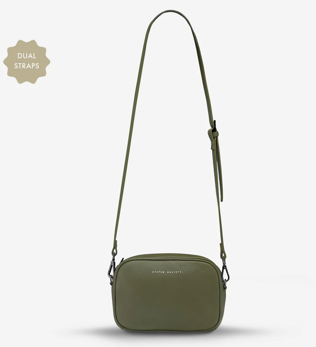 Plunder Bag With Dual Straps - Khaki - Status Anxiety 

Our best selling bag of all time now comes with two different straps for twice the versatility. Clip on the leather strap for dressier occasions, or the webbed strap for a more casual vibe. It's a no brainer.

Soft shrunken pebble leather
Comes with Leather Strap Thin & Web Strap Medium
Back slider pocket
Internal zipper pocket, and open pouch pockets
Zipper close
Custom Status Anxiety lining
Comes in a Status Anxiety branded drawstring bag