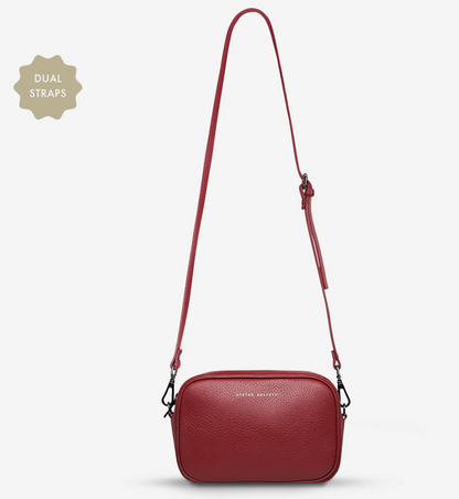 Plunder Bag With Dual Straps - Rouge - Status Anxiety 
Our best selling bag of all time now comes with two different straps for twice the versatility. Clip on the leather strap for dressier occasions, or the webbed strap for a more casual vibe. It's a no brainer.

Soft shrunken pebble leather
Comes with Leather Strap Thin & Web Strap Medium
Back slider pocket
Internal zipper pocket, and open pouch pockets
Zipper close
Custom Status Anxiety lining
Comes in a Status Anxiety branded drawstring bag