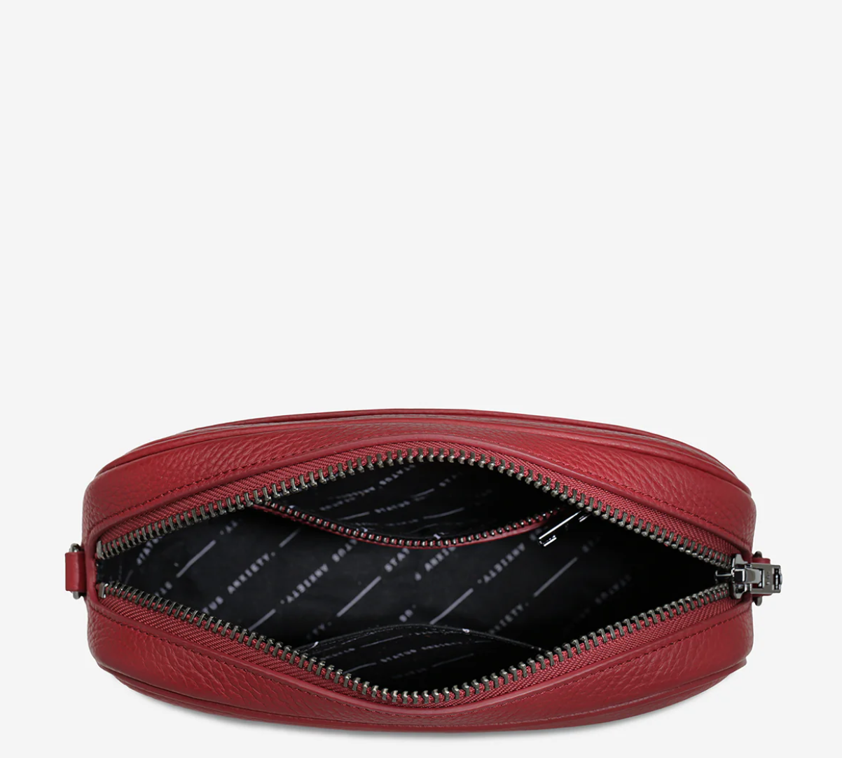 Plunder Bag With Dual Straps - Rouge - Status Anxiety 
Our best selling bag of all time now comes with two different straps for twice the versatility. Clip on the leather strap for dressier occasions, or the webbed strap for a more casual vibe. It's a no brainer.

Soft shrunken pebble leather
Comes with Leather Strap Thin & Web Strap Medium
Back slider pocket
Internal zipper pocket, and open pouch pockets
Zipper close
Custom Status Anxiety lining
Comes in a Status Anxiety branded drawstring bag
