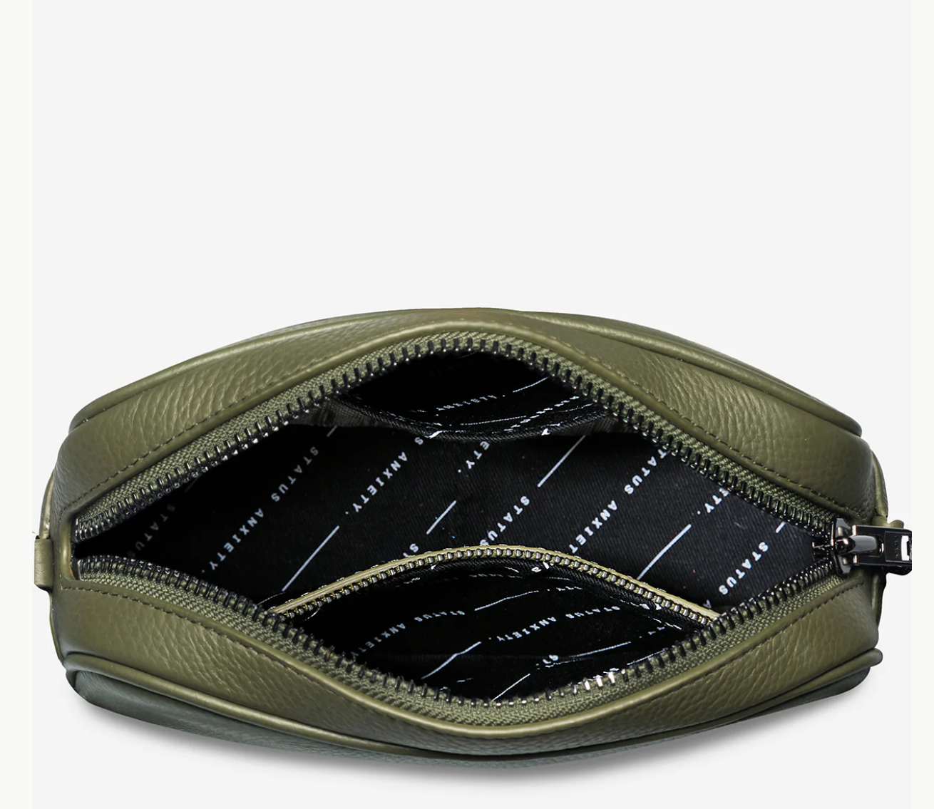Plunder Bag With Dual Straps - Khaki - Status Anxiety 

Our best selling bag of all time now comes with two different straps for twice the versatility. Clip on the leather strap for dressier occasions, or the webbed strap for a more casual vibe. It's a no brainer.

Soft shrunken pebble leather
Comes with Leather Strap Thin & Web Strap Medium
Back slider pocket
Internal zipper pocket, and open pouch pockets
Zipper close
Custom Status Anxiety lining
Comes in a Status Anxiety branded drawstring bag