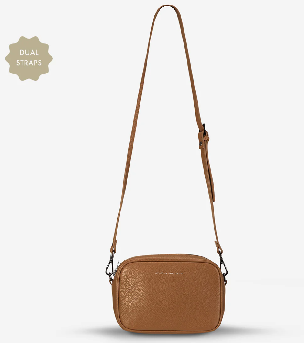Plunder Bag With Duals Straps - Camel - Status Anxiety 

Our best selling bag of all time now comes with two different straps for twice the versatility. Clip on the leather strap for dressier occasions, or the webbed strap for a more casual vibe. It's a no brainer.

Soft shrunken pebble leather
Comes with Leather Strap Thin & Web Strap Medium
Back slider pocket
Internal zipper pocket, and open pouch pockets
Zipper close
Custom Status Anxiety lining
Comes in a Status Anxiety branded drawstring bag
