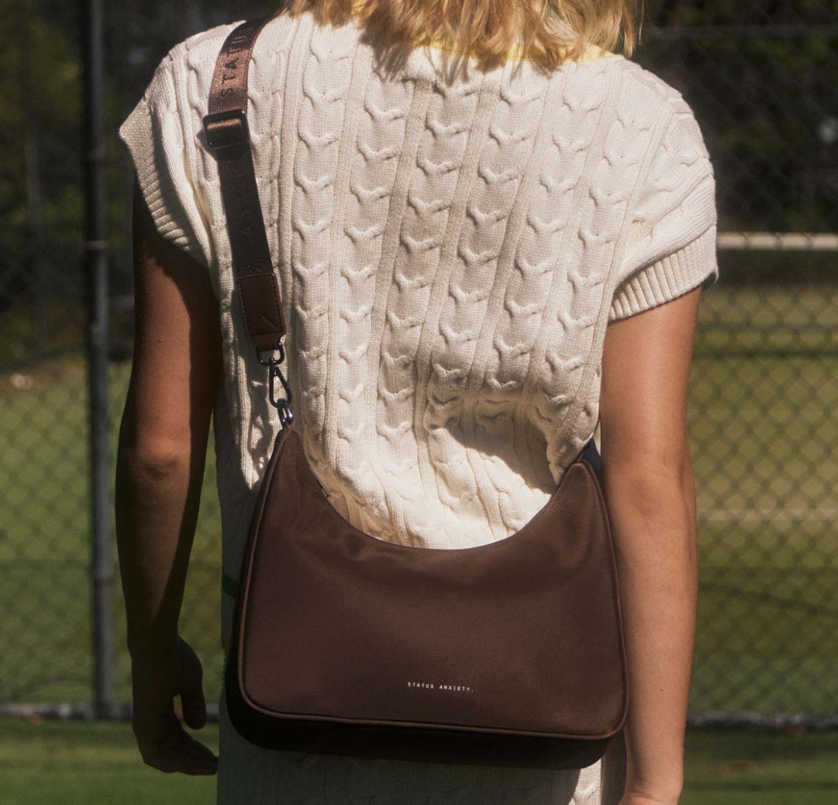 Fleur Recycled Bag - Truffle - Status Anxiety 

Versatile and deceptively roomy. 'Fleur' is made of premium reinforced recycled polyester to give it superior structure, and is finished with our branded zippers and tonal hardware. Comes equipped with dual interchangeable straps: a longer webbed strap for everyday crossbody use, and shorter shoulder strap for a dressier look. 
