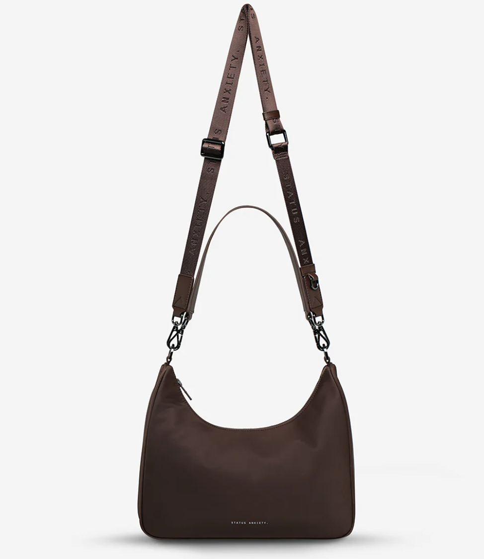 Fleur Recycled Bag - Truffle - Status Anxiety 

Versatile and deceptively roomy. 'Fleur' is made of premium reinforced recycled polyester to give it superior structure, and is finished with our branded zippers and tonal hardware. Comes equipped with dual interchangeable straps: a longer webbed strap for everyday crossbody use, and shorter shoulder strap for a dressier look. 

