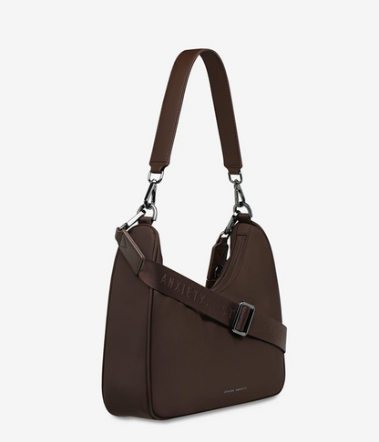Fleur Recycled Bag - Truffle - Status Anxiety 

Versatile and deceptively roomy. 'Fleur' is made of premium reinforced recycled polyester to give it superior structure, and is finished with our branded zippers and tonal hardware. Comes equipped with dual interchangeable straps: a longer webbed strap for everyday crossbody use, and shorter shoulder strap for a dressier look. 
