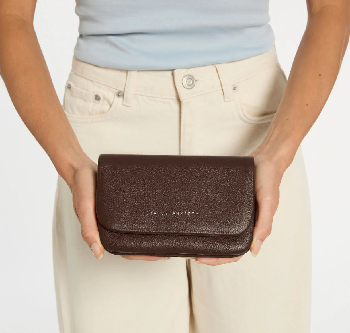 Impermanent Wallet - Cocoa - Status Anxiety 
Nothing lasts forever they say, but we can assure you that the Impermanent wallet is likely to last a bloody long time. Stash your stuff in its relaxed less structured form and slip it into your pocket or handbag.

Soft shrunken pebble leather
Custom Status Anxiety lining
6 card slots (option to double up)
Internal zipper pocket
Magnet close
Gunmetal hardware
Silver foil logo
Comes in a Status Anxiety branded drawstring bag