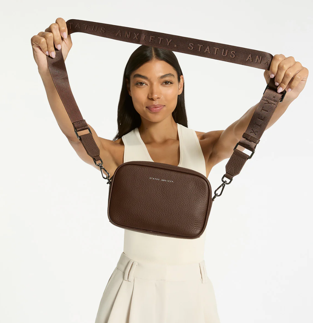 Plunder Bag With Dual Straps - Cocoa - Status Anxiety 

Our best selling bag of all time now comes with two different straps for twice the versatility. Clip on the leather strap for dressier occasions, or the webbed strap for a more casual vibe. It's a no brainer.

Soft shrunken pebble leather
Comes with Leather Strap Thin & Web Strap Medium
Back slider pocket
Internal zipper pocket, and open pouch pockets
Zipper close
Custom Status Anxiety lining
Comes in a Status Anxiety branded drawstring bag