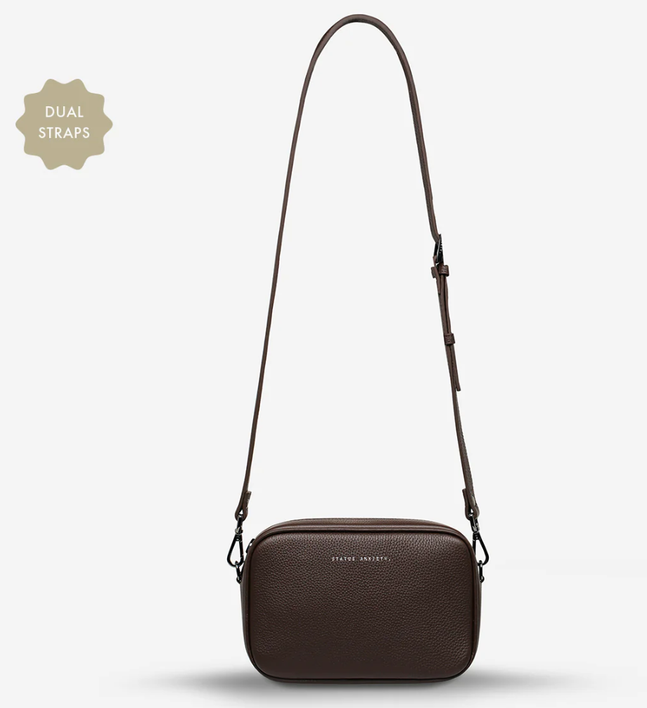 Plunder Bag With Dual Straps - Cocoa - Status Anxiety 

Our best selling bag of all time now comes with two different straps for twice the versatility. Clip on the leather strap for dressier occasions, or the webbed strap for a more casual vibe. It's a no brainer.

Soft shrunken pebble leather
Comes with Leather Strap Thin & Web Strap Medium
Back slider pocket
Internal zipper pocket, and open pouch pockets
Zipper close
Custom Status Anxiety lining
Comes in a Status Anxiety branded drawstring bag
