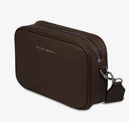 Plunder Bag With Dual Straps - Cocoa - Status Anxiety 

Our best selling bag of all time now comes with two different straps for twice the versatility. Clip on the leather strap for dressier occasions, or the webbed strap for a more casual vibe. It's a no brainer.

Soft shrunken pebble leather
Comes with Leather Strap Thin & Web Strap Medium
Back slider pocket
Internal zipper pocket, and open pouch pockets
Zipper close
Custom Status Anxiety lining
Comes in a Status Anxiety branded drawstring bag