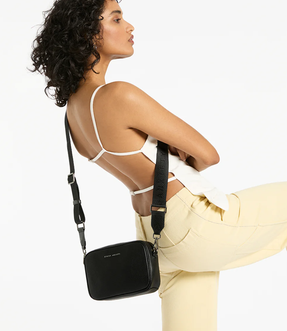 Plunder Bag Black With Duals Straps - Black - Status Anxiety 

Our best selling bag of all time now comes with two different straps for twice the versatility. Clip on the leather strap for dressier occasions, or the webbed strap for a more casual vibe. It's a no brainer.

Soft shrunken pebble leather
Comes with Leather Strap Thin & Web Strap Medium
Back slider pocket
Internal zipper pocket, and open pouch pockets
Zipper close
Custom Status Anxiety lining
Comes in a Status Anxiety branded drawstring bag