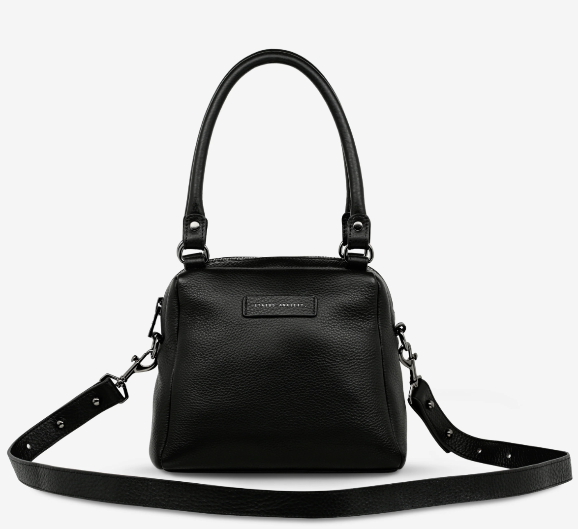 Mini Mountains Bag - Black - Status Anxiety 

Good things come in small packages. 'Mini Mountains' is a more compact version of the iconic 'Last Mountains' bag. This day to night companion can be worn on elbow, shoulder, or cross body (with included long strap). Features a wide-opening main compartment, longer shoulder strap for added comfort, and secret magnet-close pocket on the outside for your phone etc.

Soft shrunken pebble leather
Back magnet pocket
Internal zipper pocket, and open pockets