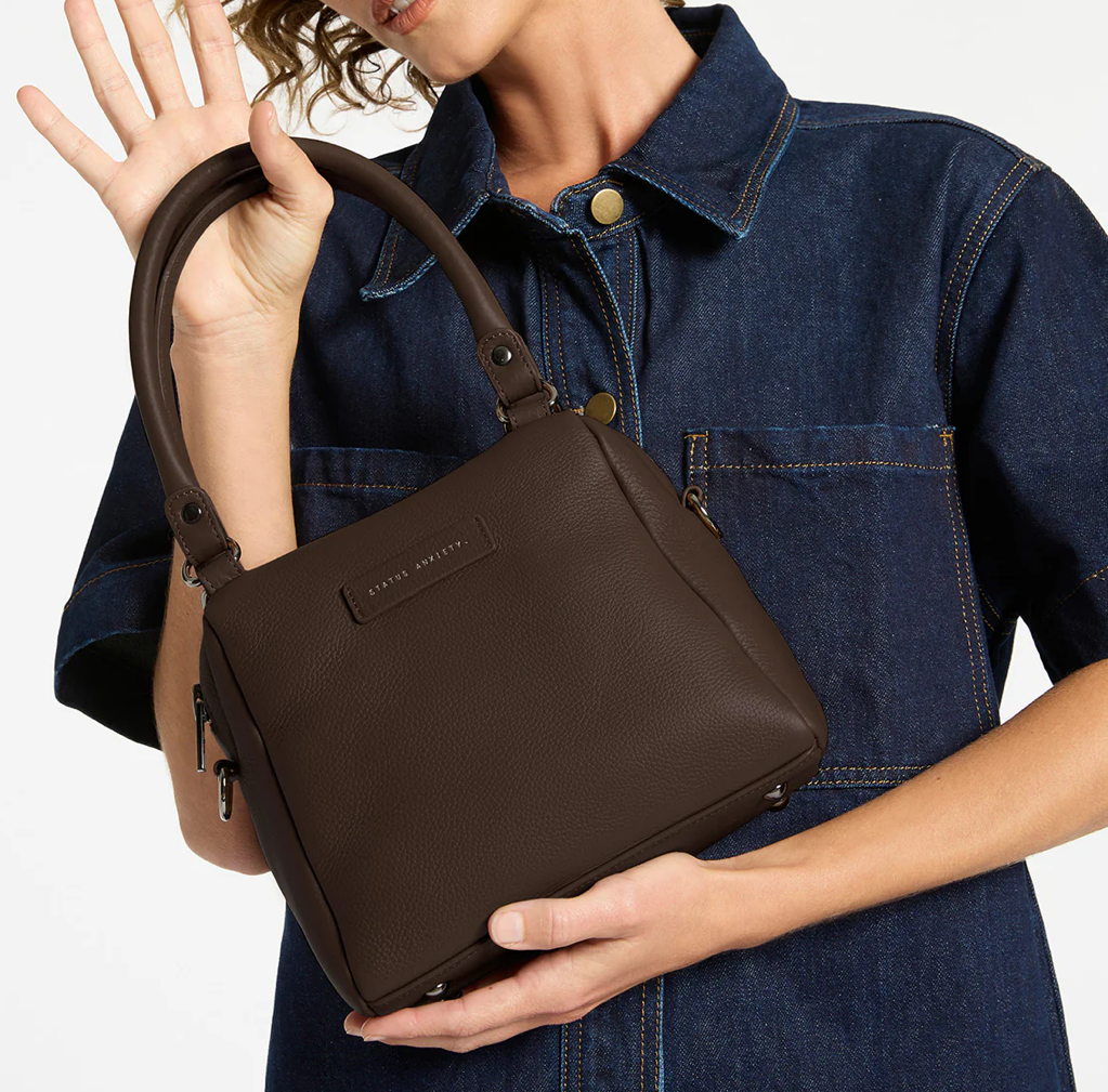 Mini Mountains Bag - Cocoa - Status Anxiety 
Good things come in small packages. 'Mini Mountains' is a more compact version of the iconic 'Last Mountains' bag. This day to night companion can be worn on elbow, shoulder, or cross body (with included long strap). Features a wide-opening main compartment, longer shoulder strap for added comfort, and secret magnet-close pocket on the outside for your phone etc.

Soft shrunken pebble leather
Back magnet pocket
Internal zipper pocket, and open pockets