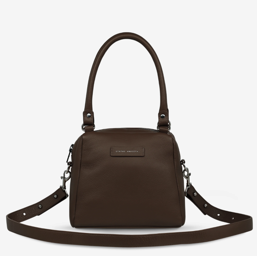 Mini Mountains Bag - Cocoa - Status Anxiety 
Good things come in small packages. 'Mini Mountains' is a more compact version of the iconic 'Last Mountains' bag. This day to night companion can be worn on elbow, shoulder, or cross body (with included long strap). Features a wide-opening main compartment, longer shoulder strap for added comfort, and secret magnet-close pocket on the outside for your phone etc.

Soft shrunken pebble leather
Back magnet pocket
Internal zipper pocket, and open pockets
