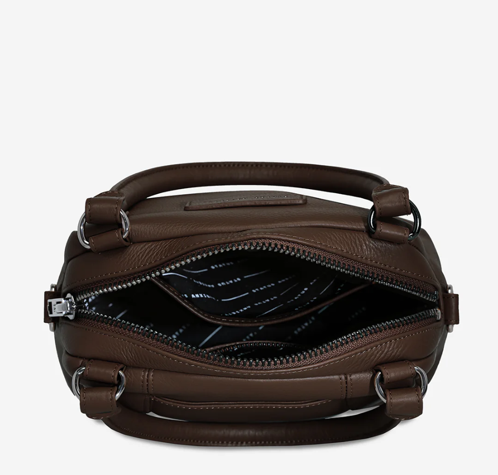 Mini Mountains Bag - Cocoa - Status Anxiety 
Good things come in small packages. 'Mini Mountains' is a more compact version of the iconic 'Last Mountains' bag. This day to night companion can be worn on elbow, shoulder, or cross body (with included long strap). Features a wide-opening main compartment, longer shoulder strap for added comfort, and secret magnet-close pocket on the outside for your phone etc.

Soft shrunken pebble leather
Back magnet pocket
Internal zipper pocket, and open pockets