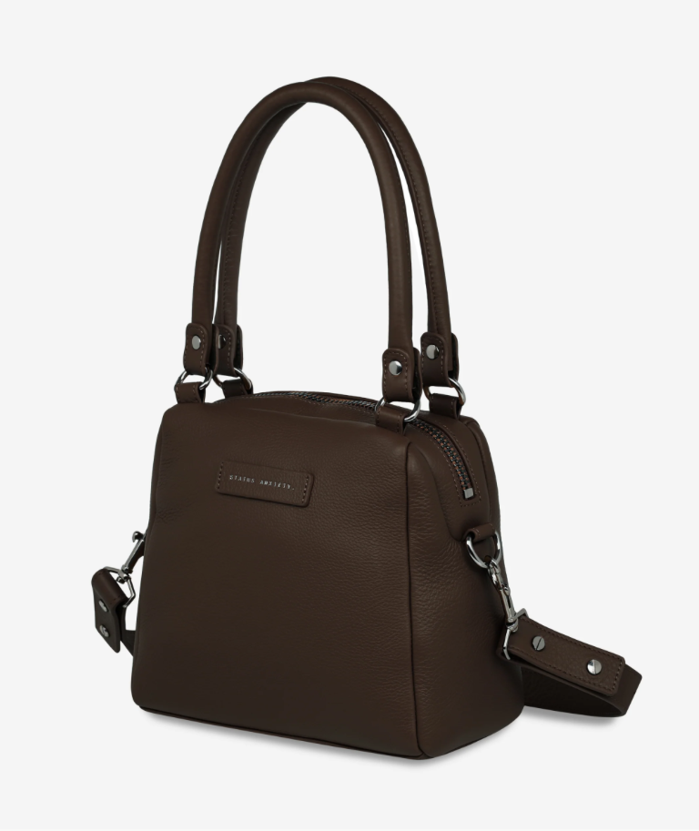 Mini Mountains Bag - Cocoa - Status Anxiety 
Good things come in small packages. 'Mini Mountains' is a more compact version of the iconic 'Last Mountains' bag. This day to night companion can be worn on elbow, shoulder, or cross body (with included long strap). Features a wide-opening main compartment, longer shoulder strap for added comfort, and secret magnet-close pocket on the outside for your phone etc.

Soft shrunken pebble leather
Back magnet pocket
Internal zipper pocket, and open pockets