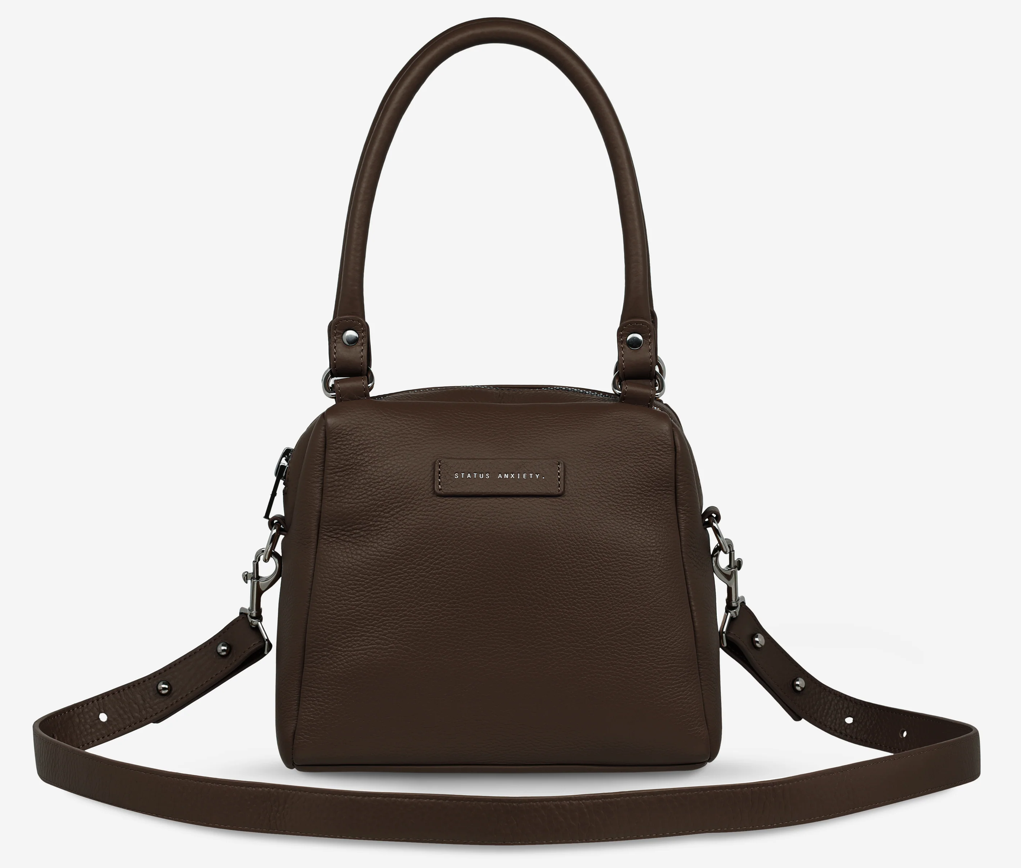 Mini Mountains Bag - Cocoa - Status Anxiety 
Good things come in small packages. 'Mini Mountains' is a more compact version of the iconic 'Last Mountains' bag. This day to night companion can be worn on elbow, shoulder, or cross body (with included long strap). Features a wide-opening main compartment, longer shoulder strap for added comfort, and secret magnet-close pocket on the outside for your phone etc.

Soft shrunken pebble leather
Back magnet pocket
Internal zipper pocket, and open pockets