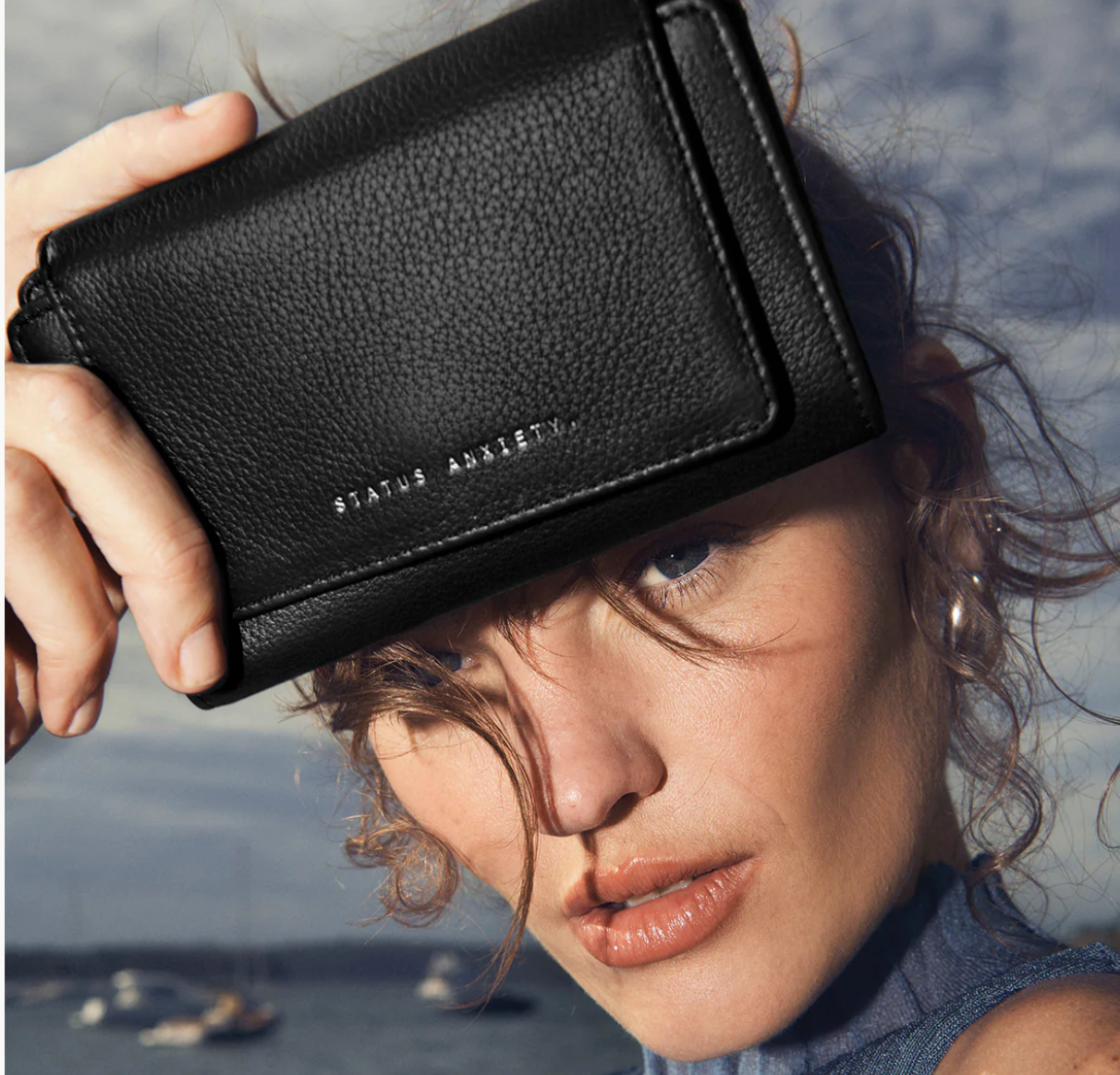 Visions Wallet - Status Anxiety 
Coming to us in a dream, the 'Visions' wallet will handle all your essentials in its slim and compact silhouette. Features space for cards, banknotes, an external zip pocket for easy access to loose change, and a closure flap to keep everything securely stashed away.

Soft shrunken pebble leather
Custom Status Anxiety lining
12 card slots (each fit 1-2 cards)
Back zipper pocket
Folded banknote space
Gunmetal hardware
Silver foil logo
Comes in a recycled stock Status Anxiety 