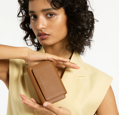 Visions Wallet - Status Anxiety 
Coming to us in a dream, the 'Visions' wallet will handle all your essentials in its slim and compact silhouette. Features space for cards, banknotes, an external zip pocket for easy access to loose change, and a closure flap to keep everything securely stashed away.

Soft shrunken pebble leather
Custom Status Anxiety lining
12 card slots (each fit 1-2 cards)
Back zipper pocket
Folded banknote space
Gunmetal hardware
Silver foil logo
Comes in a recycled stock Status Anxiety 