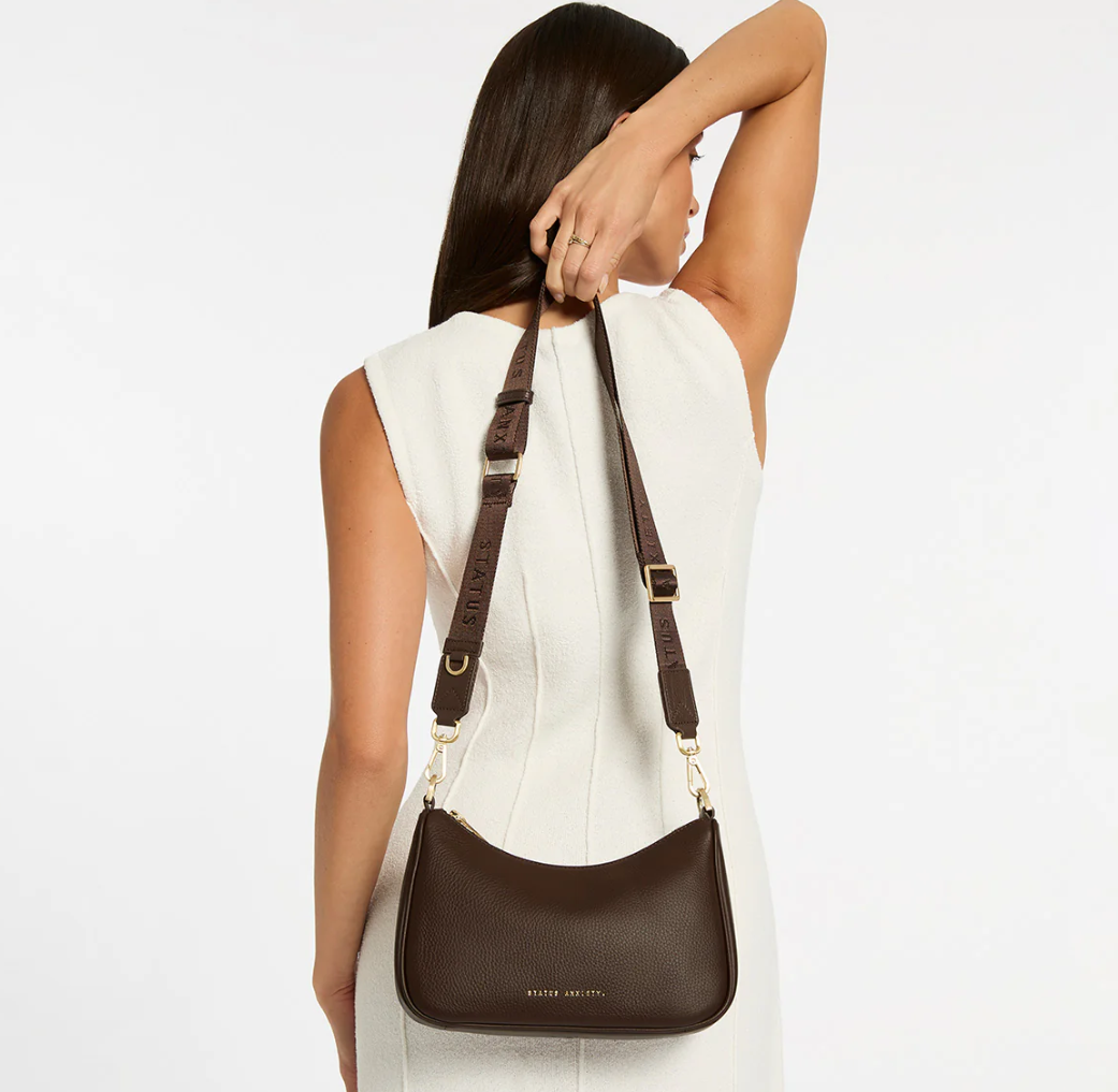 Look Both Ways Bag - Cocoa & Brushed Gold - Status Anxiety 

The 'Look Both Ways' bag will keep people guessing with her dual personality straps. Use the shorter shoulder strap for a dressier on-the-go look or go the longer web strap option to give off a more casual 'I don't have plans today' vibe.

Soft shrunken pebble leather
Brushed gold hardware
Internal zipper pocket, and card slots
Dual straps (short leather strap & thin webbed strap)
Custom Status Anxiety lining
