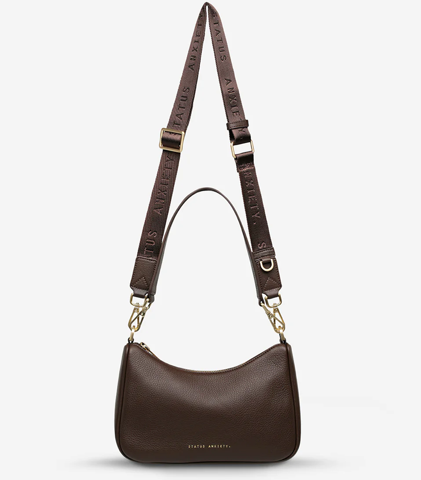 Look Both Ways Bag - Cocoa & Brushed Gold - Status Anxiety 

The 'Look Both Ways' bag will keep people guessing with her dual personality straps. Use the shorter shoulder strap for a dressier on-the-go look or go the longer web strap option to give off a more casual 'I don't have plans today' vibe.

Soft shrunken pebble leather
Brushed gold hardware
Internal zipper pocket, and card slots
Dual straps (short leather strap & thin webbed strap)
Custom Status Anxiety lining
