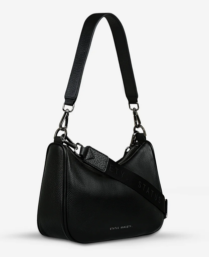 Look Both Ways Bag - Black - Status Anxiety 
The 'Look Both Ways' bag will keep people guessing with her dual personality straps. Use the shorter shoulder strap for a dressier on-the-go look or go the longer webbed strap option to give off a more casual 'I don't have plans today' vibe.

Soft shrunken pebble leather
Comes with leather shoulder strap and long webbed strap
Internal zipper pocket one side and 3 card slots on the other
Black custom Status Anxiety lining
20cm x 14cm x 7cm
Leather strap length 26c