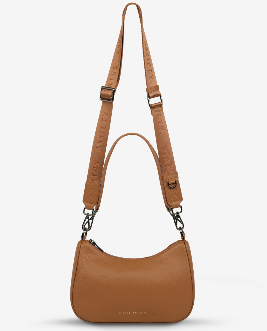 The 'Look Both Ways' bag will keep people guessing with her dual personality straps. Use the shorter shoulder strap for a dressier on-the-go look or go the longer web strap option to give off a more casual 'I don't have plans today' vibe.

Soft shrunken pebble leather
Internal zipper pocket, and card slots
Dual straps (short leather strap & thin webbed strap)
Custom Status Anxiety lining
Comes in a Status Anxiety branded drawstring bag