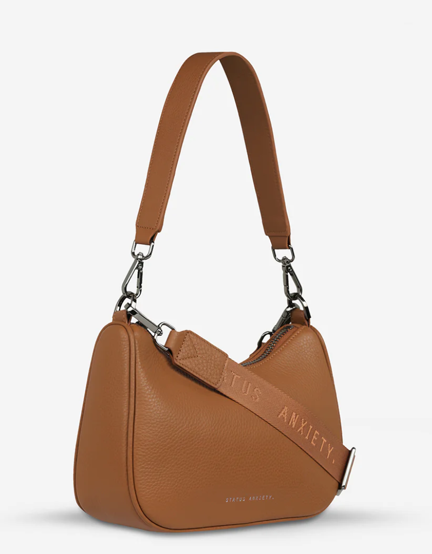 The 'Look Both Ways' bag will keep people guessing with her dual personality straps. Use the shorter shoulder strap for a dressier on-the-go look or go the longer web strap option to give off a more casual 'I don't have plans today' vibe.

Soft shrunken pebble leather
Internal zipper pocket, and card slots
Dual straps (short leather strap & thin webbed strap)
Custom Status Anxiety lining
Comes in a Status Anxiety branded drawstring bag