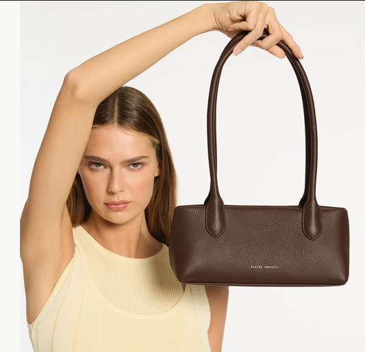 The Lost Bag - Cocoa - Status Anxiety 

Not everything that’s lost needs finding. 'The Lost' carries itself with quiet confidence – structured yet soft, refined yet unpretentious. Featuring an easy magnetic closure, internal lipstick and zipper pockets, and enough space for what really matters.

Soft shrunken pebble leather
Internal zipper pocket, and lipstick pocket
Long structured shoulder straps
Magnet closure
Custom Status Anxiety lining
Comes in a Status Anxiety branded drawstring bag