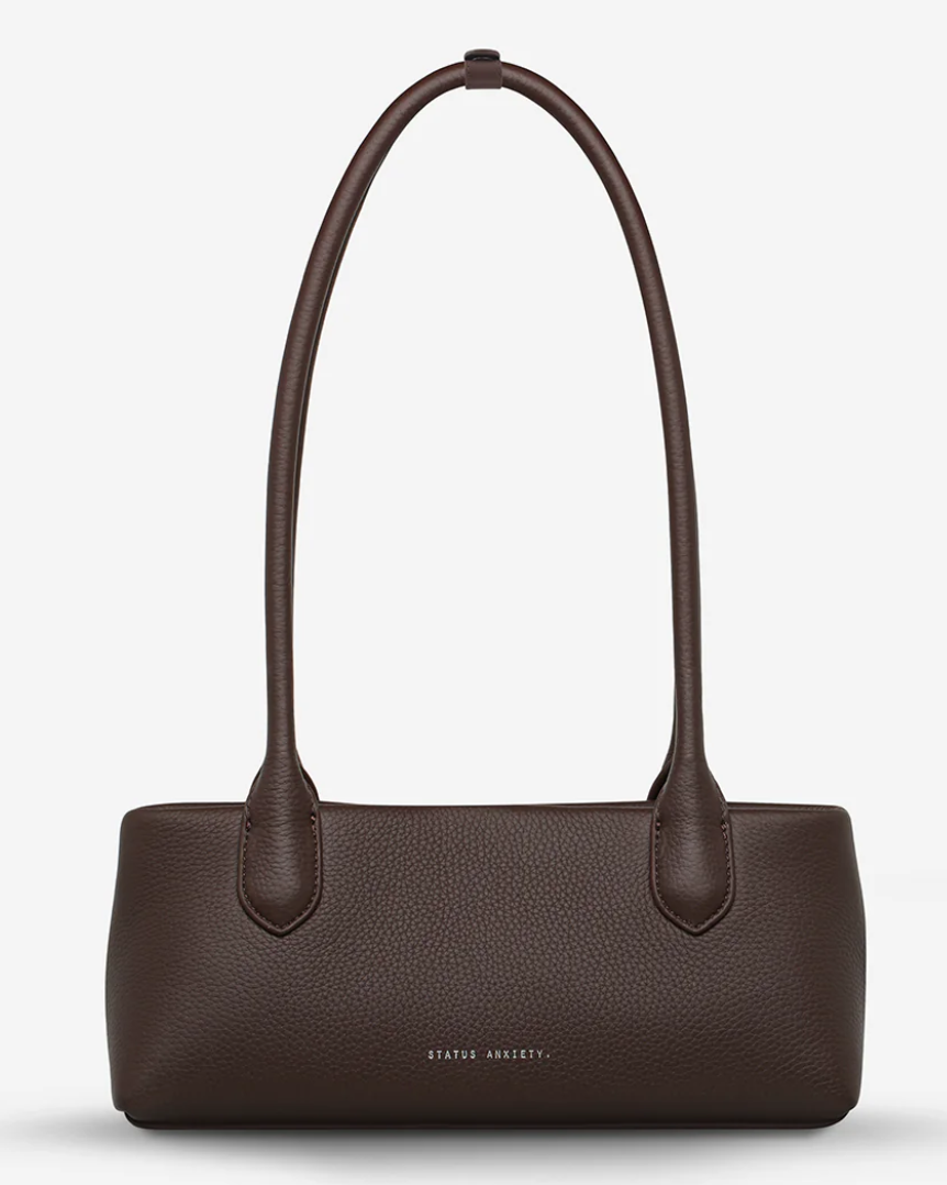 The Lost Bag - Cocoa - Status Anxiety 

Not everything that’s lost needs finding. 'The Lost' carries itself with quiet confidence – structured yet soft, refined yet unpretentious. Featuring an easy magnetic closure, internal lipstick and zipper pockets, and enough space for what really matters.

Soft shrunken pebble leather
Internal zipper pocket, and lipstick pocket
Long structured shoulder straps
Magnet closure
Custom Status Anxiety lining
Comes in a Status Anxiety branded drawstring bag