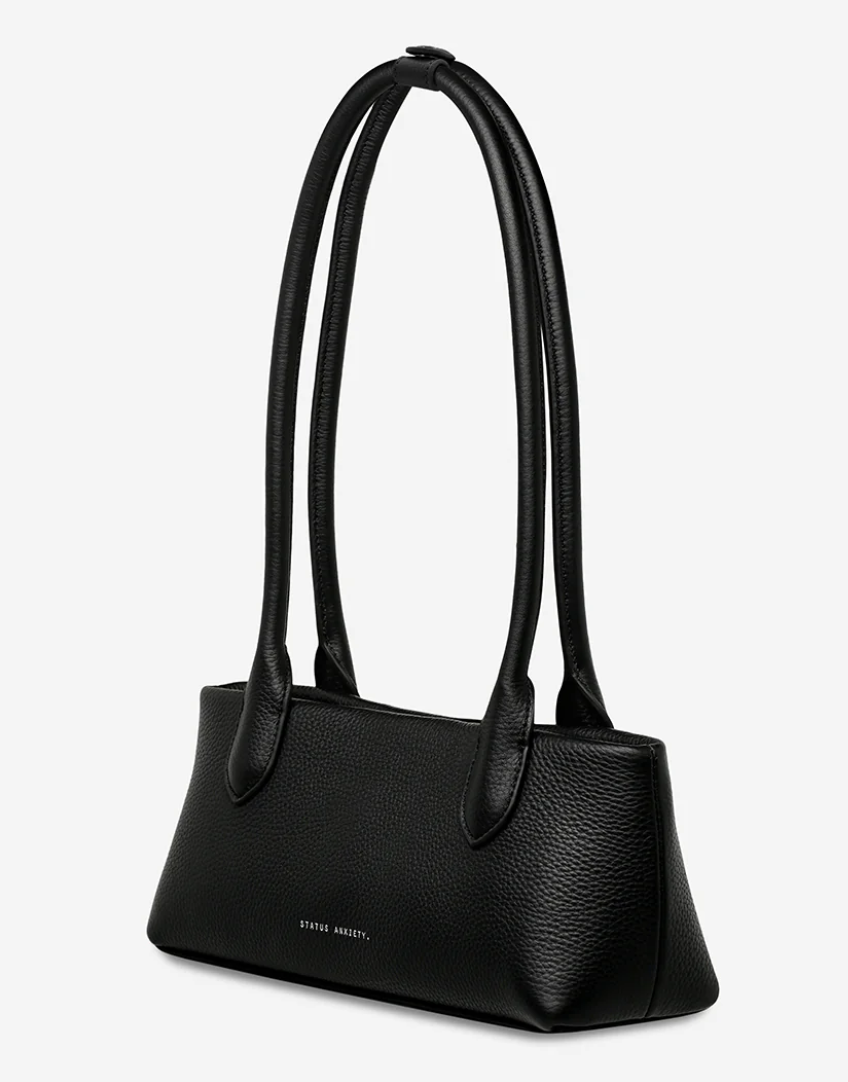 The Lost Bag - Black - Status Anxiety 

Not everything that’s lost needs finding. 'The Lost' carries itself with quiet confidence – structured yet soft, refined yet unpretentious. Featuring an easy magnetic closure, internal lipstick and zipper pockets, and enough space for what really matters.

Soft shrunken pebble leather
Internal zipper pocket, and lipstick pocket
Long structured shoulder straps
Magnet closure
Custom Status Anxiety lining
Comes in a Status Anxiety branded drawstring bag
