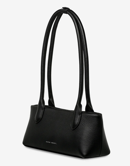 The Lost Bag - Black - Status Anxiety 

Not everything that’s lost needs finding. 'The Lost' carries itself with quiet confidence – structured yet soft, refined yet unpretentious. Featuring an easy magnetic closure, internal lipstick and zipper pockets, and enough space for what really matters.

Soft shrunken pebble leather
Internal zipper pocket, and lipstick pocket
Long structured shoulder straps
Magnet closure
Custom Status Anxiety lining
Comes in a Status Anxiety branded drawstring bag