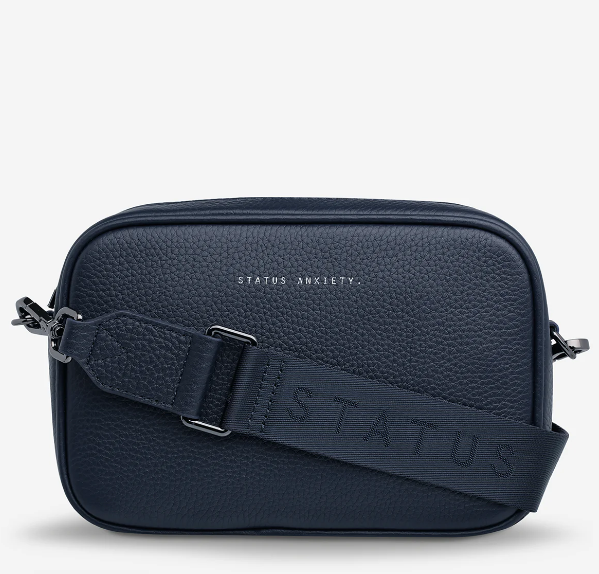 Plunder Bag With Dual Straps - Midnight Blue - Status Anxiety 
Our best selling bag of all time now comes with two different straps for twice the versatility. Clip on the leather strap for dressier occasions, or the webbed strap for a more casual vibe. It's a no brainer.

Soft shrunken pebble leather
Comes with Leather Strap Thin & Web Strap Medium
Back slider pocket
Internal zipper pocket, and open pouch pockets
Zipper close
Custom Status Anxiety lining
Comes in a Status Anxiety branded drawstring bag