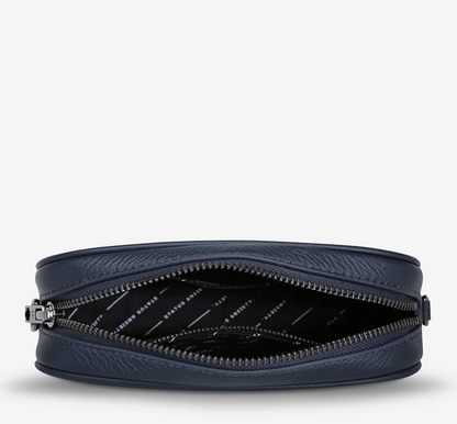 Plunder Bag With Dual Straps - Midnight Blue - Status Anxiety 
Our best selling bag of all time now comes with two different straps for twice the versatility. Clip on the leather strap for dressier occasions, or the webbed strap for a more casual vibe. It's a no brainer.

Soft shrunken pebble leather
Comes with Leather Strap Thin & Web Strap Medium
Back slider pocket
Internal zipper pocket, and open pouch pockets
Zipper close
Custom Status Anxiety lining
Comes in a Status Anxiety branded drawstring bag