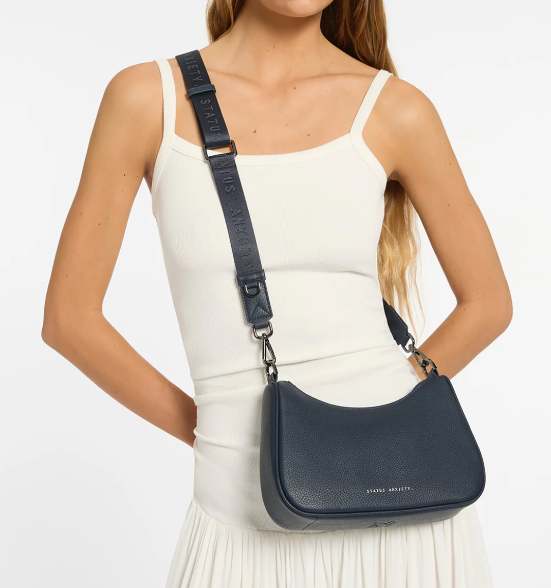 Look Both Ways Bag - Midnight Blue - Status Anxiety 

The 'Look Both Ways' bag will keep people guessing with her dual personality straps. Use the shorter shoulder strap for a dressier on-the-go look or go the longer web strap option to give off a more casual 'I don't have plans today' vibe.

Soft shrunken pebble leather
Internal zipper pocket, and card slots
Dual straps (short leather strap & thin webbed strap)
Custom Status Anxiety lining
Comes in a Status Anxiety branded drawstring bag