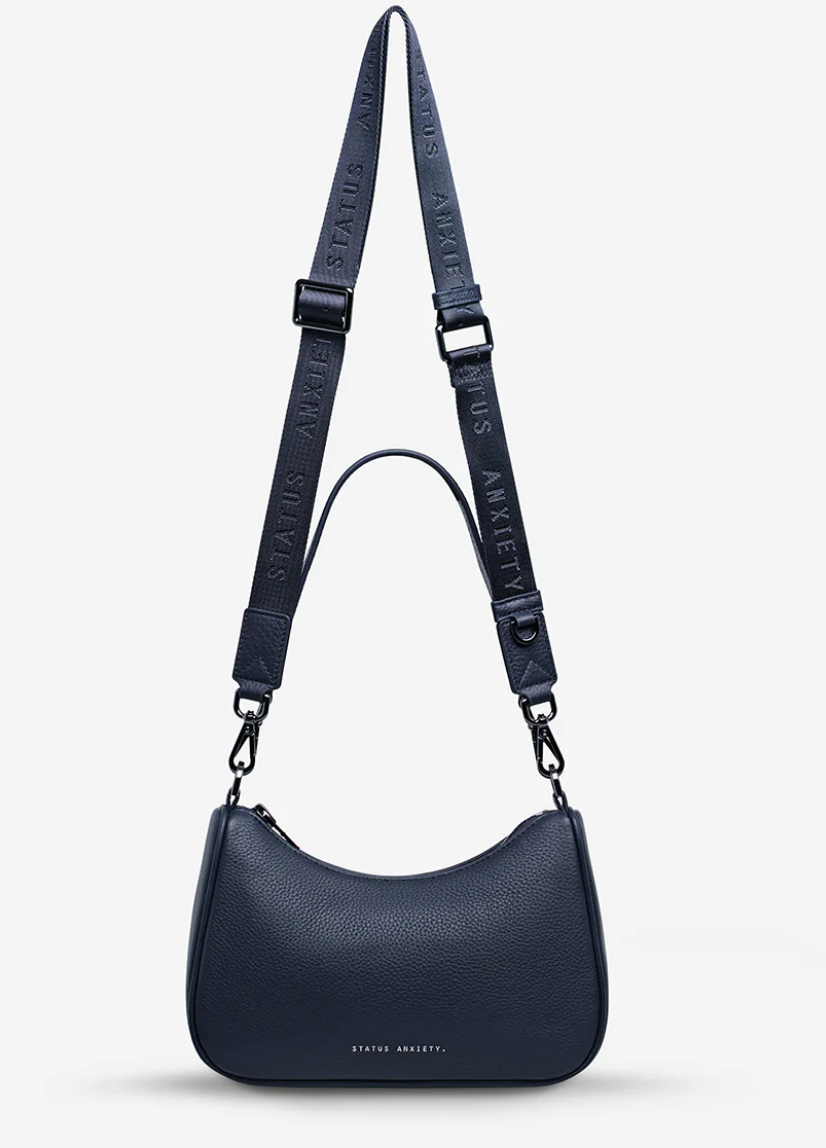 Look Both Ways Bag - Midnight Blue - Status Anxiety 

The 'Look Both Ways' bag will keep people guessing with her dual personality straps. Use the shorter shoulder strap for a dressier on-the-go look or go the longer web strap option to give off a more casual 'I don't have plans today' vibe.

Soft shrunken pebble leather
Internal zipper pocket, and card slots
Dual straps (short leather strap & thin webbed strap)
Custom Status Anxiety lining
Comes in a Status Anxiety branded drawstring bag