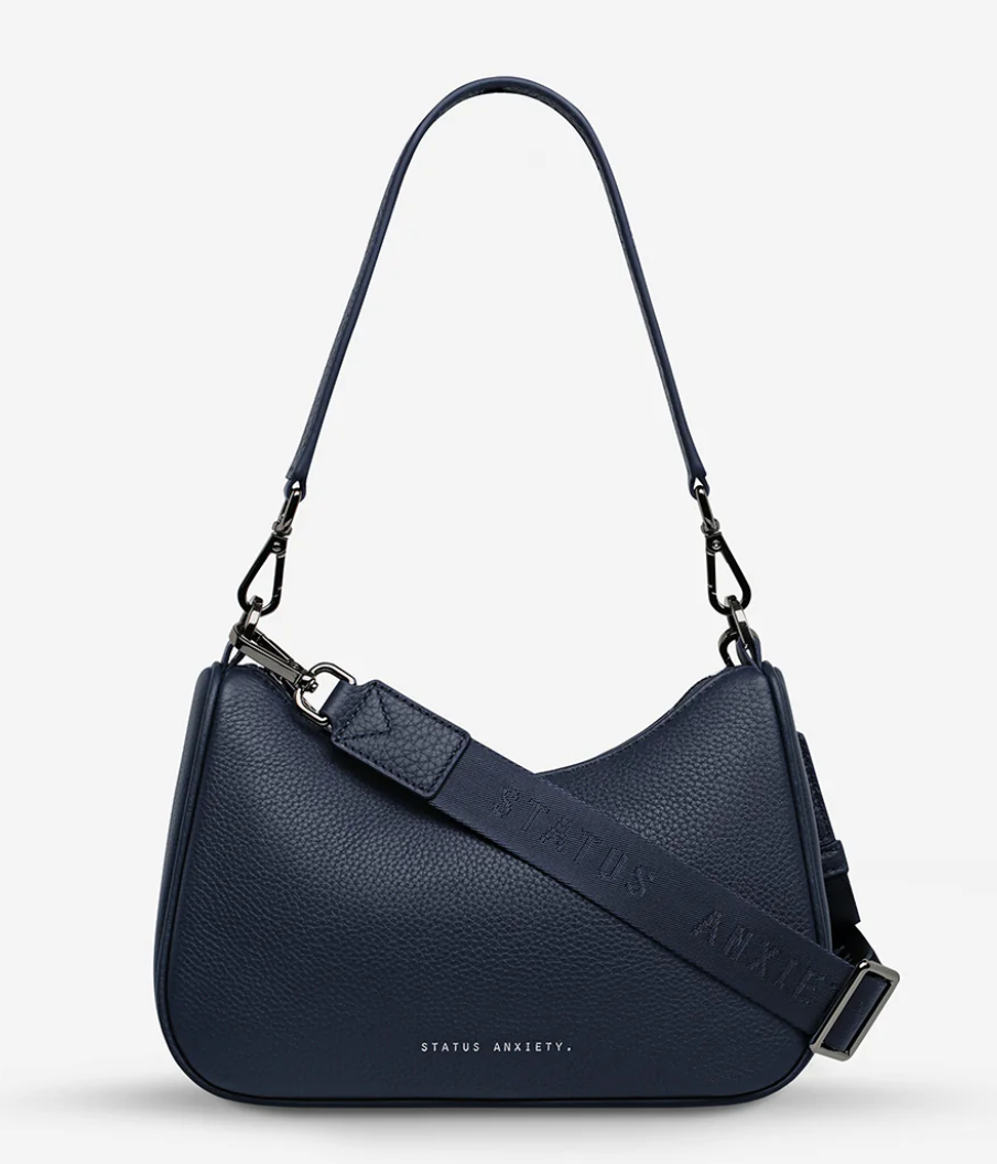 Look Both Ways Bag - Midnight Blue - Status Anxiety 

The 'Look Both Ways' bag will keep people guessing with her dual personality straps. Use the shorter shoulder strap for a dressier on-the-go look or go the longer web strap option to give off a more casual 'I don't have plans today' vibe.

Soft shrunken pebble leather
Internal zipper pocket, and card slots
Dual straps (short leather strap & thin webbed strap)
Custom Status Anxiety lining
Comes in a Status Anxiety branded drawstring bag