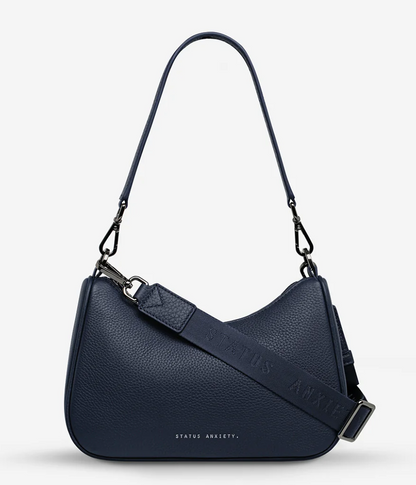 Look Both Ways Bag - Midnight Blue - Status Anxiety 

The 'Look Both Ways' bag will keep people guessing with her dual personality straps. Use the shorter shoulder strap for a dressier on-the-go look or go the longer web strap option to give off a more casual 'I don't have plans today' vibe.

Soft shrunken pebble leather
Internal zipper pocket, and card slots
Dual straps (short leather strap & thin webbed strap)
Custom Status Anxiety lining
Comes in a Status Anxiety branded drawstring bag