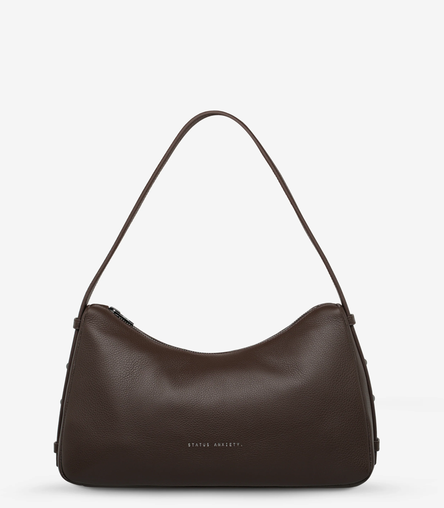 Hideout Bag - Cocoa - Status Anxiety 

Understated in design and quietly capable in size, 'Hideout' keeps things simple with its soft, slouchy shape and attitude.

Soft shrunken pebble leather
Internal zipper pocket, lipstick pocket, and open pouch pocket
Zipper closure
Custom Status Anxiety lining
Comes in a Status Anxiety branded drawstring bag