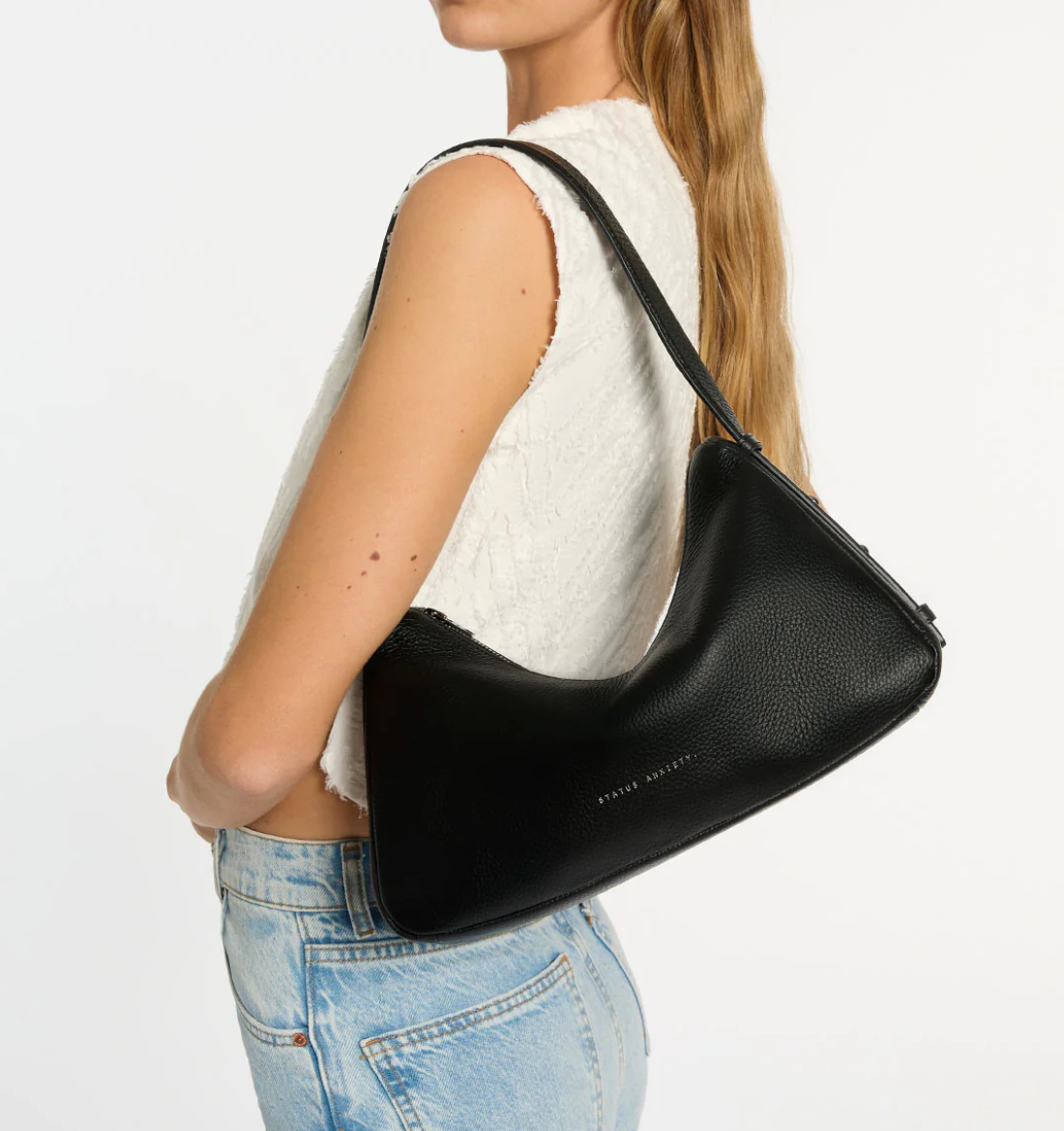 Hideout Bag - Black - Status Anxiety 

Understated in design and quietly capable in size, 'Hideout' keeps things simple with its soft, slouchy shape and attitude.

Soft shrunken pebble leather
Internal zipper pocket, lipstick pocket, and open pouch pocket
Zipper closure
Custom Status Anxiety lining
Comes in a Status Anxiety branded drawstring bag