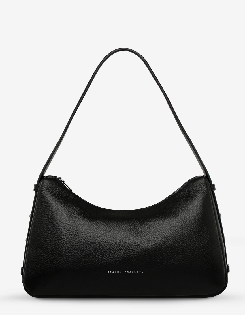 Hideout Bag - Black - Status Anxiety 

Understated in design and quietly capable in size, 'Hideout' keeps things simple with its soft, slouchy shape and attitude.

Soft shrunken pebble leather
Internal zipper pocket, lipstick pocket, and open pouch pocket
Zipper closure
Custom Status Anxiety lining
Comes in a Status Anxiety branded drawstring bag