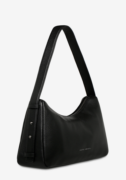 Hideout Bag - Black - Status Anxiety 

Understated in design and quietly capable in size, 'Hideout' keeps things simple with its soft, slouchy shape and attitude.

Soft shrunken pebble leather
Internal zipper pocket, lipstick pocket, and open pouch pocket
Zipper closure
Custom Status Anxiety lining
Comes in a Status Anxiety branded drawstring bag