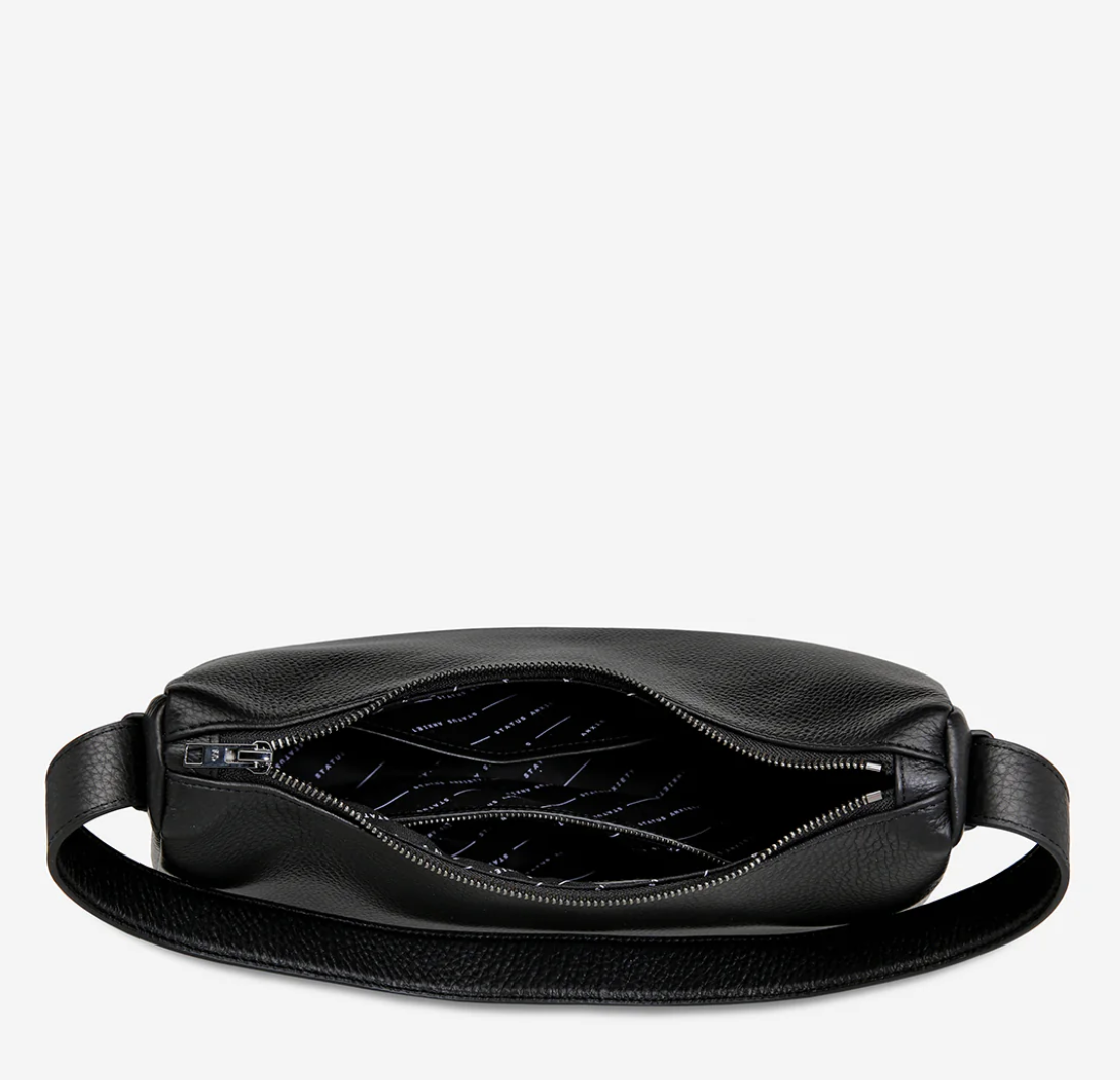 Hideout Bag - Black - Status Anxiety 

Understated in design and quietly capable in size, 'Hideout' keeps things simple with its soft, slouchy shape and attitude.

Soft shrunken pebble leather
Internal zipper pocket, lipstick pocket, and open pouch pocket
Zipper closure
Custom Status Anxiety lining
Comes in a Status Anxiety branded drawstring bag