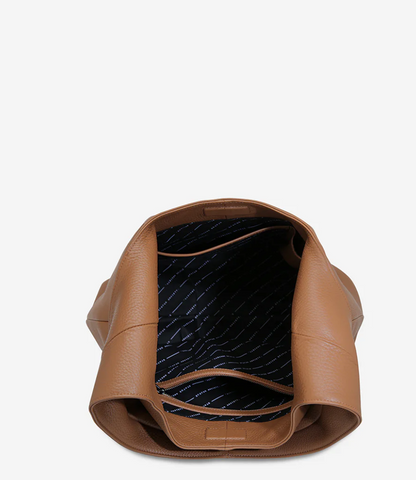 Solstice Bag - Camel - Status Anxiety 
Relaxed yet reliable, 'Solstice' is a slouchy tote that carries more than it lets on (including a 13-inch laptop). Soft, spacious, and closed with the snap of a magnet, 'Solstice' is unstructured and easygoing in all the right ways.

Soft shrunken pebble leather
Internal zipper pocket, lipstick pocket, and open pouch pocket
Fits a 13-inch laptop
Magnet closure
Custom Status Anxiety lining
Comes in a Status Anxiety branded drawstring bag