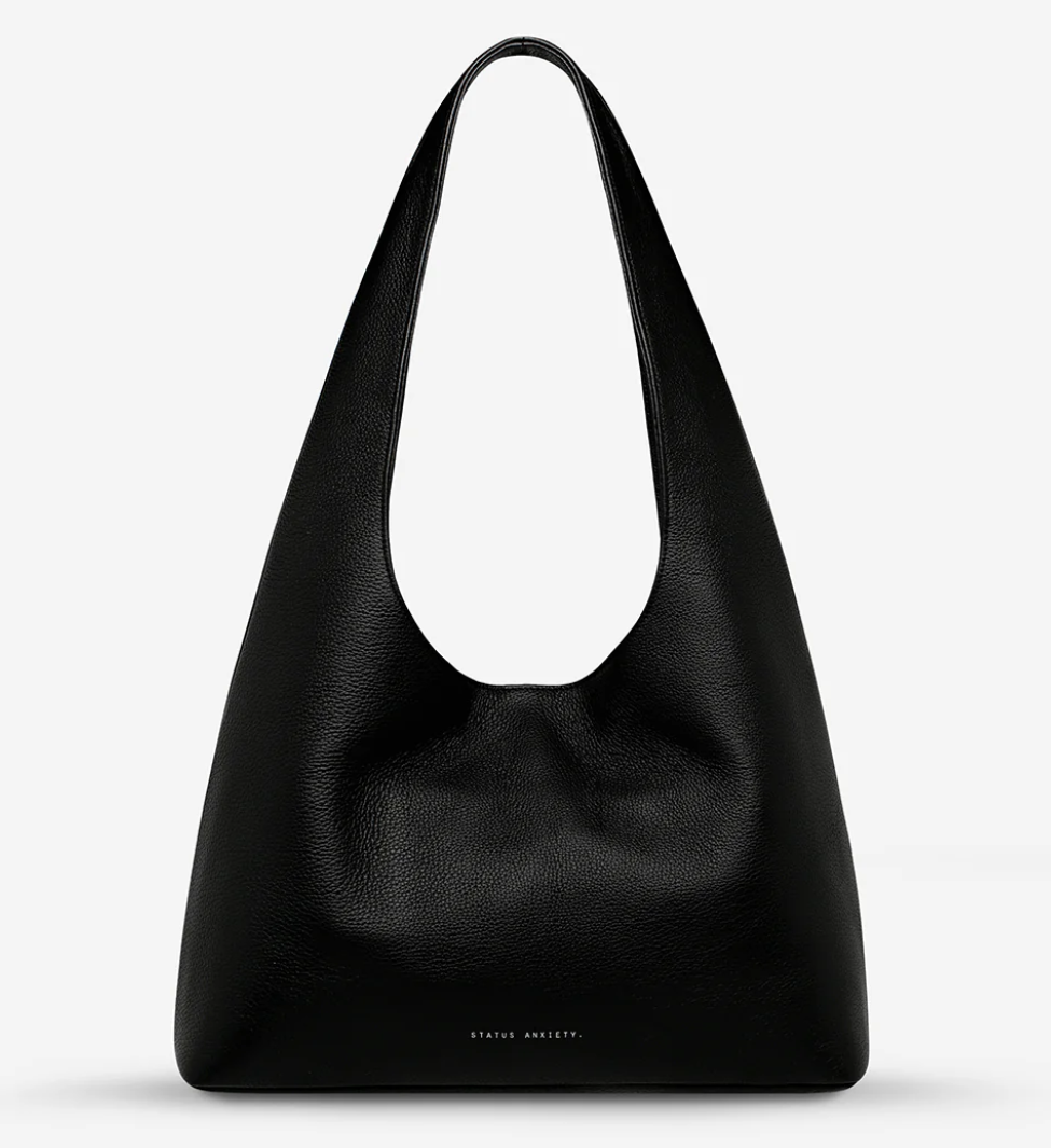 Solstice Bag - Black - Status Anxiety 

Relaxed yet reliable, 'Solstice' is a slouchy tote that carries more than it lets on (including a 13-inch laptop). Soft, spacious, and closed with the snap of a magnet, 'Solstice' is unstructured and easygoing in all the right ways.

Soft shrunken pebble leather
Internal zipper pocket, lipstick pocket, and open pouch pocket
Fits a 13-inch laptop
Magnet closure
Custom Status Anxiety lining
Comes in a Status Anxiety branded drawstring bag